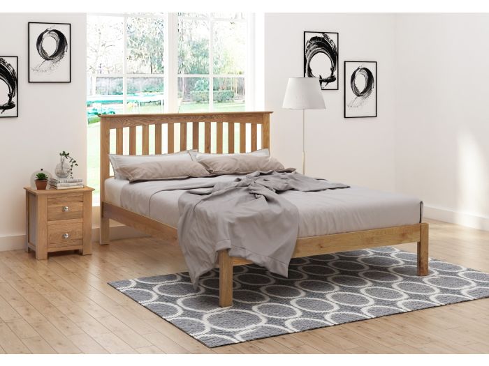 A stylish solid oak bed frame with a slatted headboard with plinth and low foot end.