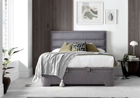 A luxurious contemporary ottoman bed frame with a modern horizontal padded headboard in grey fabric